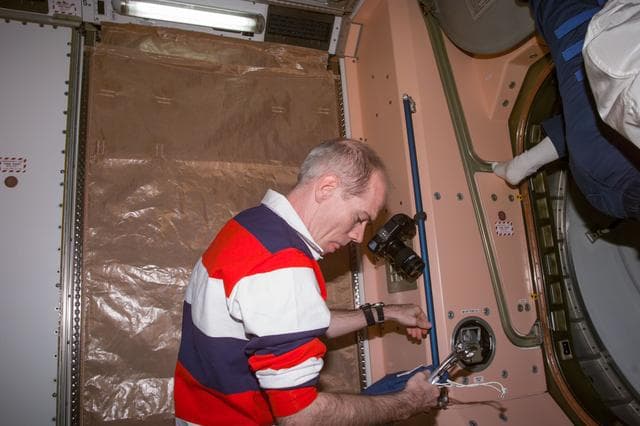 NASA image: Daniel Barry in Node 1/Unity module with tools