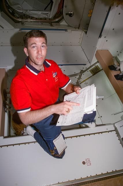 NASA image: Pilot Rick Husband in Node 1/Unity module with checklist