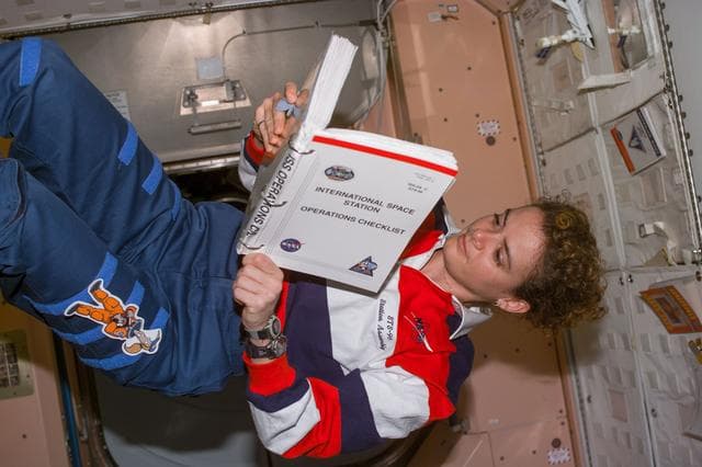 NASA image: Julie Payette reads ISS Operations Checklist in the Node 1/Unity module