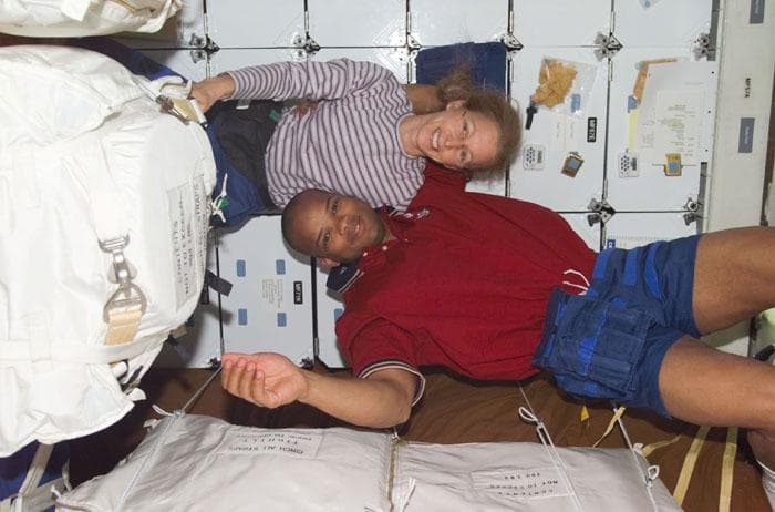 NASA image: MS Ivins and Curbeam on middeck with stowage bags