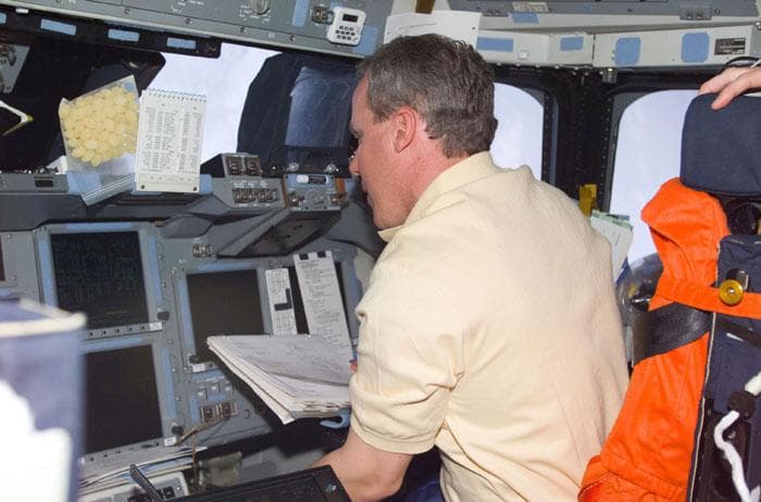 NASA image: MS Jones with checklist on flight deck of Atlantis