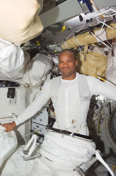 NASA image: MS Curbeam donning his EMU