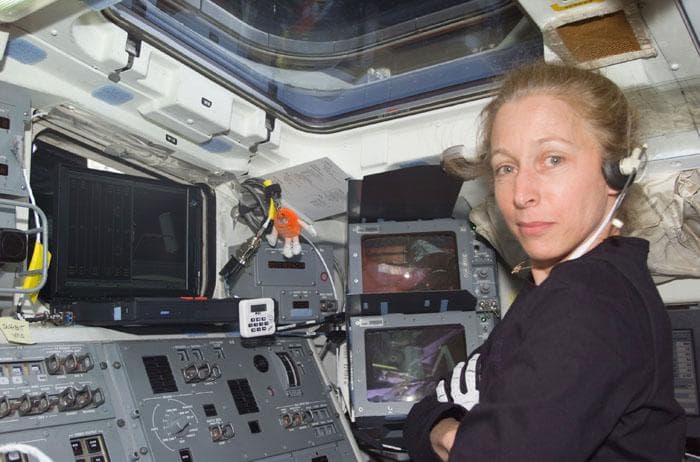 NASA image: MS Ivins at the Atlantis aft flight deck controls