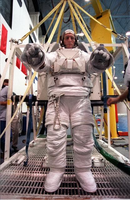 NASA image: STS-99 crewmembers Kavandi and Thiel suit up in EMUs for NBL training