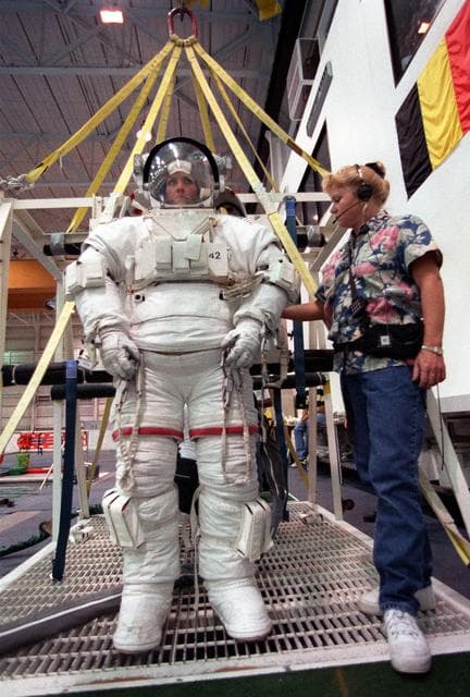 NASA image: STS-99 crewmembers Kavandi and Thiel suit up in EMUs for NBL training