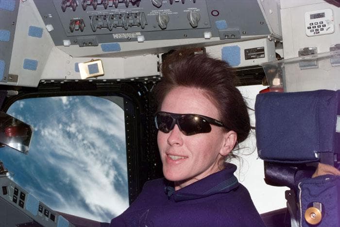 NASA image: STS-99 MS Kavandi looks over a checklist on OV-105's aft flight deck