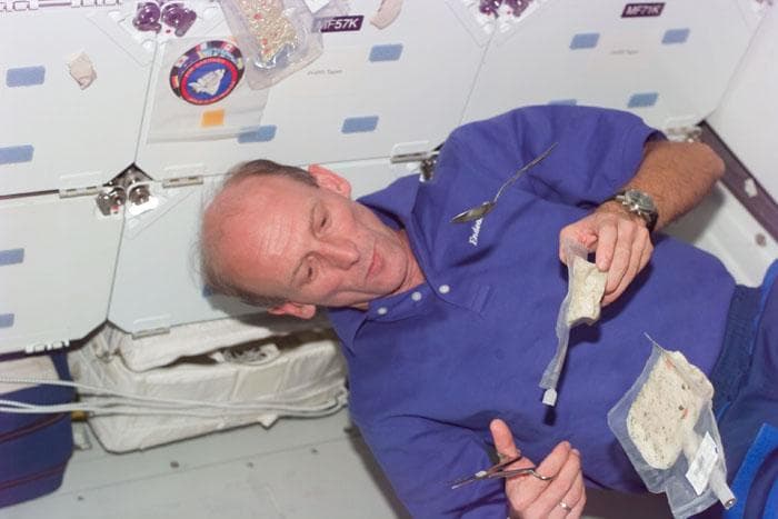 NASA image: STS-99 MS Thiele eats a meal on OV-105's middeck