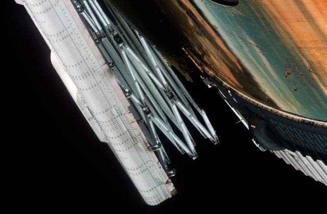 NASA image: Close-up view of partially deployed, damaged solar array