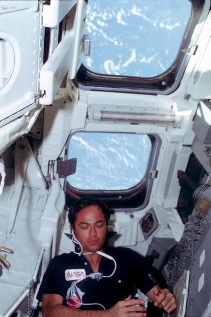 NASA image: Pilot Crippen eats rehydrated food at aft flight deck onorbit station