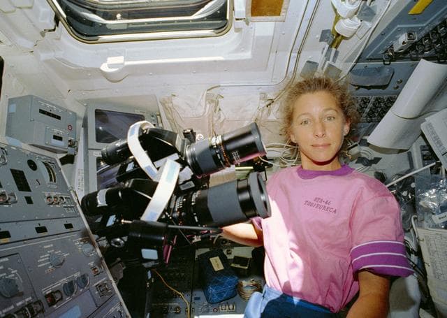 NASA image: STS-46 Mission Specialist Ivins with HASSELBLAD cameras on OV-104 flight deck