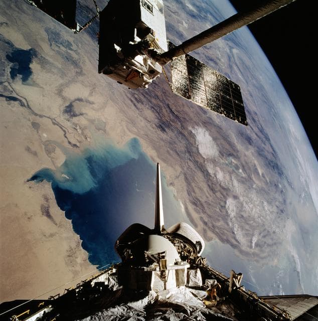 NASA image: OV-104's RMS grapples EURECA-1L and holds it in deployment position above PLB