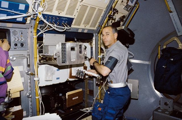 NASA image: Crewmember in spacelab with the Generic Bioprocessing Apparatus, rack # 10.