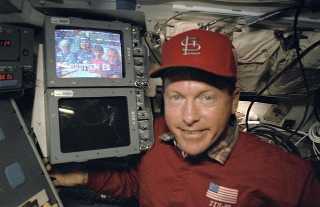 NASA image: Crewmember and video monitor during combined video and SAREX broadcast.