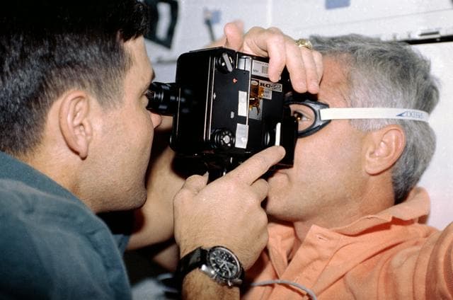 NASA image: Crewmembers in the middeck with the Retinal Photography experiment.