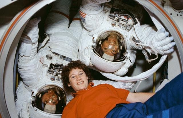 NASA image: EVA Crewmembers emerging from the air lock into the middeck.