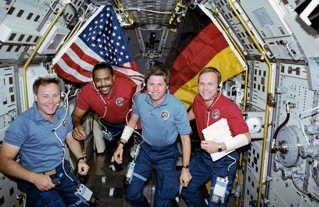 NASA image: STS-55 crewmembers pose with U.S. and German flags in SL-D2 module on OV-102