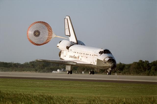 NASA image: STS-56 Discovery, OV-103, with drag chute deployed lands on KSC SLF runway 33