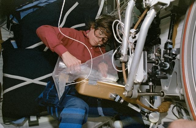 NASA image: STS-57 MS4 Voss, wearing goggles, handles SCG equipment on OV-105's middeck