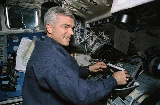 NASA image: Astronaut Rich Clifford inserts tape into payload high data recorder