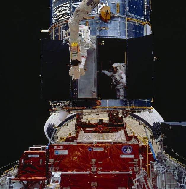 NASA image: Astronauts Akers and Thornton install COSTAR during EVA for HST repair