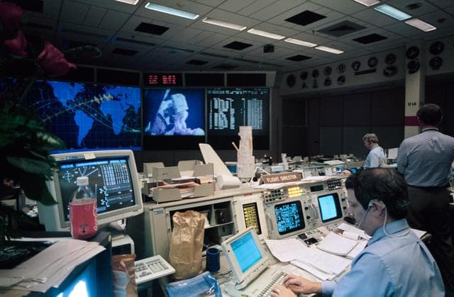 NASA image: Flight Director Robert Castle uses laptop while monitoring space walk