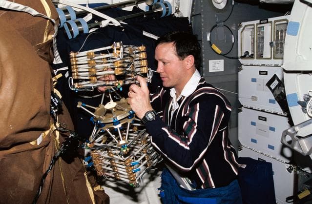 NASA image: Astronaut Pierre Thuot works with Middeck O-Gravity Dynamics Experiment