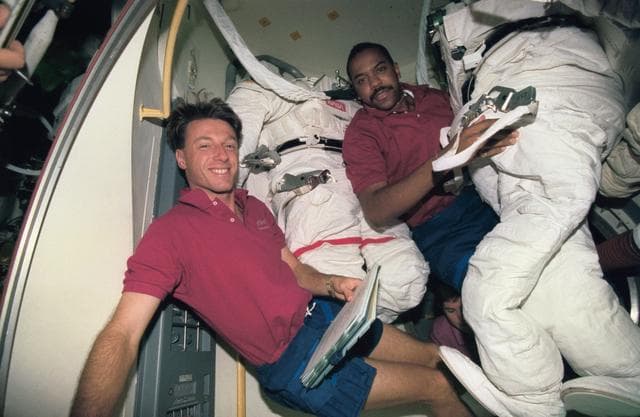 NASA image: Astronauts Foale and Harris prepare suit prior to EVA