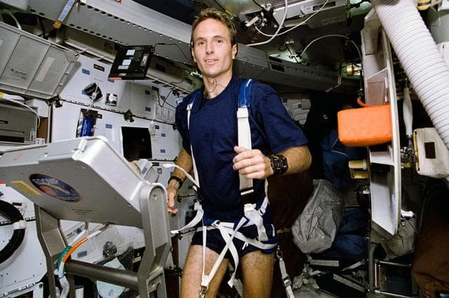 NASA image: Astronaut Jerry Linenger works out on treadmill device on middeck