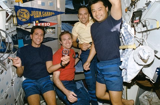 NASA image: STS-65 astronauts & 1990 Astronaut Class 13 members pose on OV-102's middeck