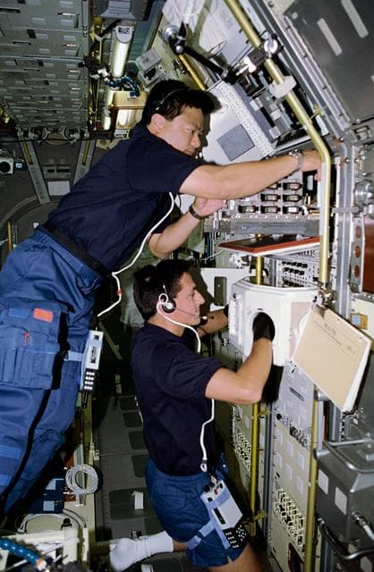 NASA image: STS-65 crewmembers work at IML-2 Rack 5 Biorack (BR) aboard Columbia, OV-102