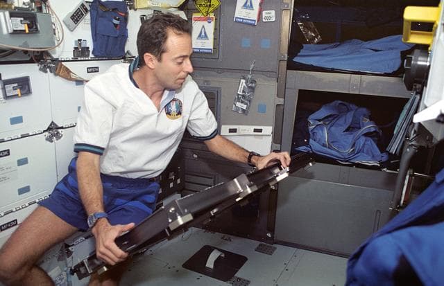 NASA image: Astronaut Jean-Francois Clervoy with platform for recumbent seat