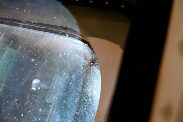 NASA image: Documentation of debris impact damage to flight deck window