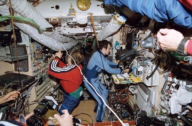 NASA image: Cosmonauts Solovyev and Dezhurov exchange information on Mir