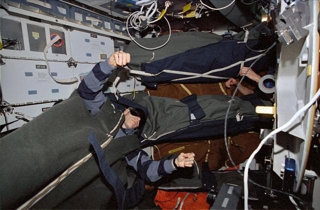 NASA image: Astronaut Daniel T. Barry asleep in the middeck