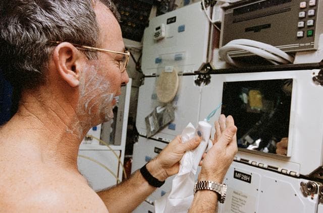 NASA image: Astronaut Brian Duffy shaves in the middeck