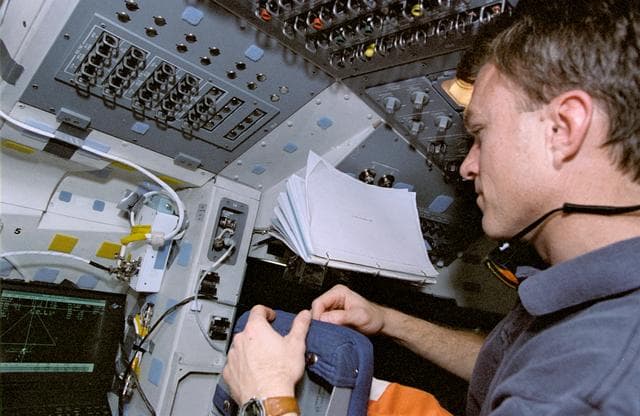 NASA image: Astronaut Brent Jett monitors display during rendezvous operations
