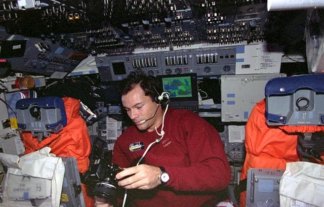 NASA image: Mission Specialist Michael Lopez-Alegria changes out film in camera