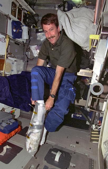 NASA image: Pilot Kent Rominger compacts trash container
