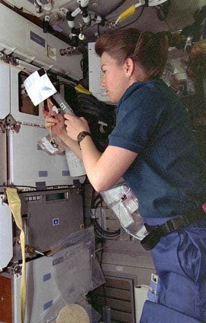 ASC, Mission Specialist Catherine "Cady" Coleman works with middeck experiment