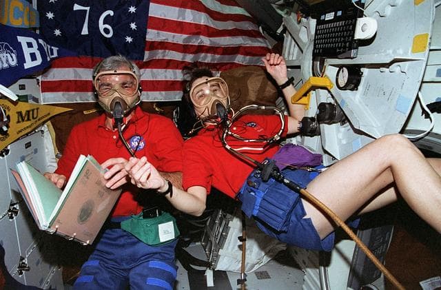NASA image: Michael "Rich" Clifford and Linda Godwin wear masks during pre-breathe