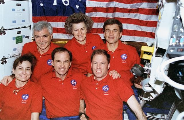 NASA image: Crew portrait in middeck in front of "Spirit of 76" flag