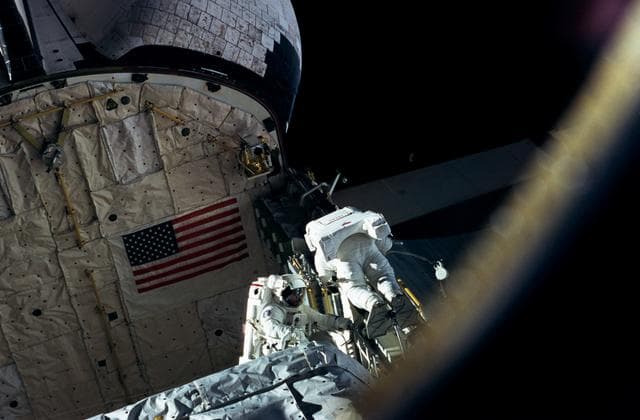 NASA image: Astronauts Linda Godwin and Michael "Rich" Clifford perform EVA