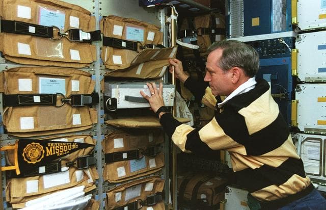 NASA image: Astronaut Akers in Spacehab with stowage items