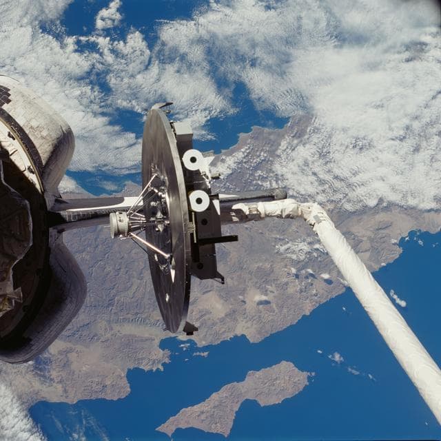NASA image: WSF, unberthing of satellite by RMS arm