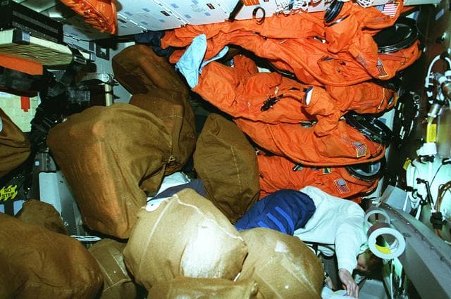 NASA image: STS-81 crew on middeck preparing for re-entry