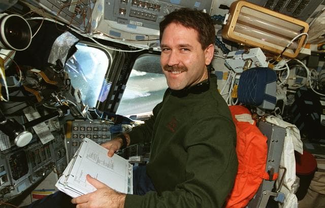 NASA image: MS Grunsfeld at pilot's station on forward flight deck