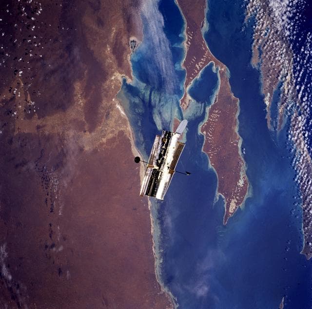 NASA image: HST, flyaround of the telescope after deployment on this second servicing mission