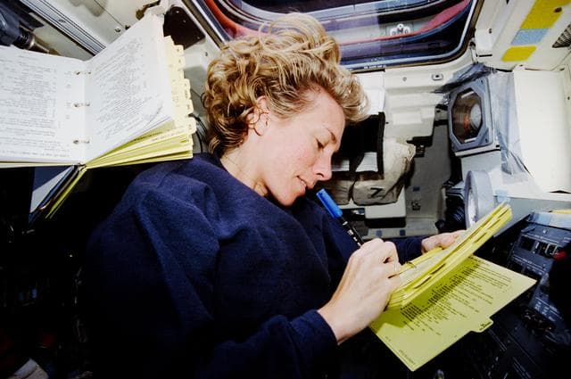 NASA image: Pilot Still makes notes on aft flight deck