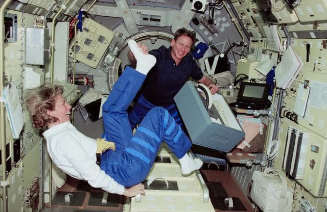 NASA image: Pilot Still and MS Gernhardt with stowage locker