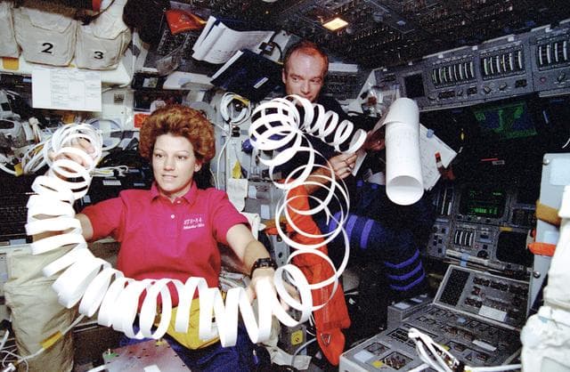 NASA image: Crewmembers with TIPS paper in flight deck